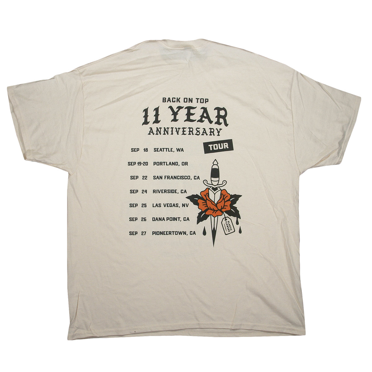Cream-colored Gildan Heavy Cotton t-shirt featuring a dagger piercing a rose, with 11 Year Anniversary Tour text and a list of tour dates and cities.